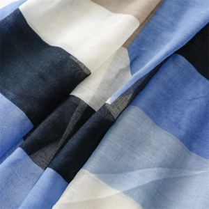 Macro detail of breathable cotton-linen scarf with geometric color block pattern