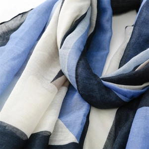 Close-up of lightweight cotton-linen scarf fabric with geometric patchwork texture