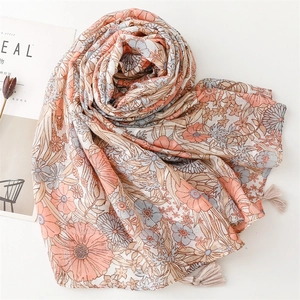Detail of floral print scarf with soft beige tassels and intricate vintage patterns