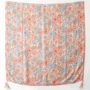 Floral cotton linen scarf with silver silk thread and beige tassels on a white background