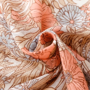 Detail of soft cotton-linen scarf with vintage pink floral patterns and silver lurex silk