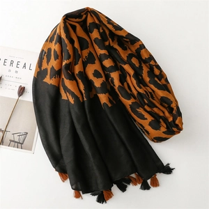 Fashionable leopard print and black shawl with soft fringe details on white background