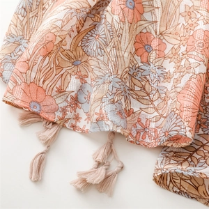 Detail of floral cotton linen scarf featuring silver thread jacquard and soft brown tassels