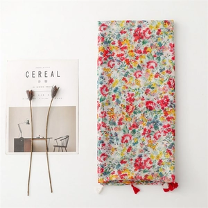 Floral cotton linen scarf with colorful prints and tassel fringe on white background