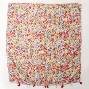 Floral print linen-feel shawl with colorful patterns and fringed tassels on white background