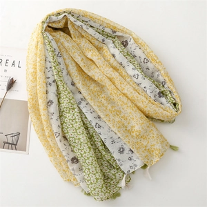 Long patchwork floral scarf in yellow and green with elegant tassel edge trim