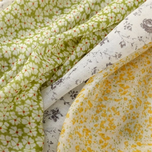 Macro detail of breathable cotton-linen scarf fabric with fresh floral patterns