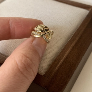 Gold-plated geometric crisscross ear cuff with micro-pave cubic zirconia on hand