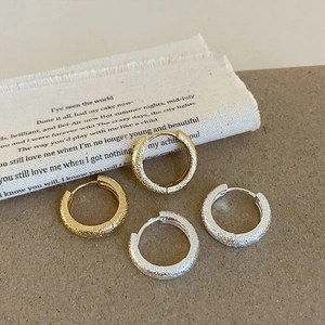 Textured stardust geometric hoop earrings in matte gold and silver finishes