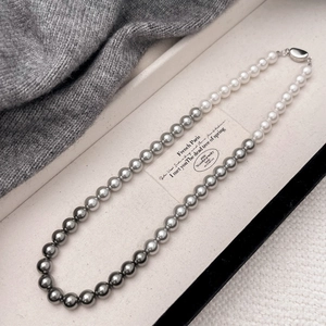 Handmade gradient pearl necklace in three colors displayed on a luxury white jewelry box