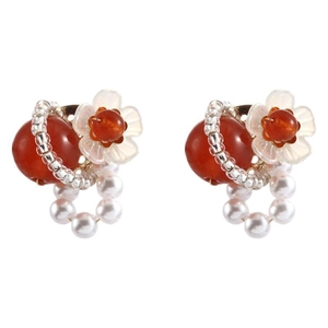 Elegant floral pearl earrings featuring red beads and white flowers on white background