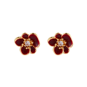 Macro shot of red enamel flower earrings with gold plating and center cubic zirconia