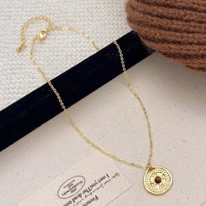 Detail of vintage tiger eye stone pendant necklace with gold chain and lobster clasp