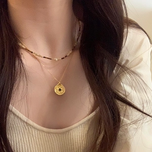 Vintage tiger eye beaded necklace with a golden coin pendant on a double-layered chain
