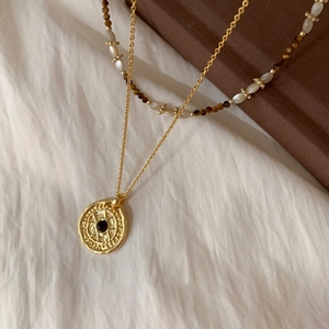 Vintage layered necklace with tiger eye beads, pearls, and gold celestial disc pendant
