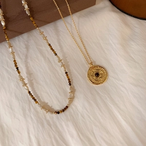 Vintage layered tiger eye bead necklace with elegant gold relief medallion pendant
