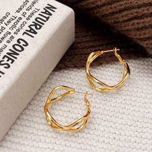 Elegant gold hollow twisted hoop earrings with irregular geometric winding design for women