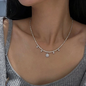 Elegant silver pearl choker with round zircon pendants on a model's collarbone