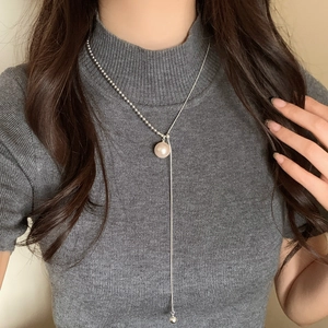 Asymmetrical Y-shaped pearl necklace with silver chain on model for elegant styling