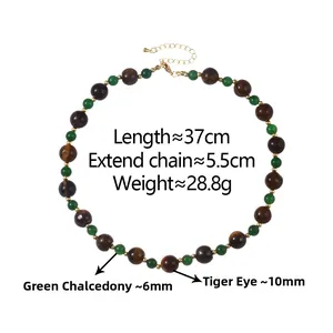 Detail of tiger eye and green chalcedony beaded necklace with golden lobster clasp and chain