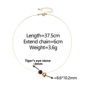 Detail of tiger eye bead and gold heart pendant on adjustable 37.5cm chain necklace