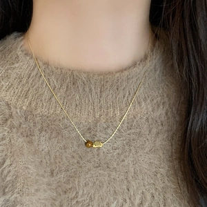 French vintage tiger eye beaded necklace with gold bean pendant on model neck