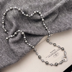 Elegant grey pearl necklace with zircon-encrusted clasp on knit fabric and gift box