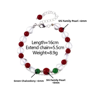 Detail of beaded bracelet with red beads, green chalcedony and heart crystal charm