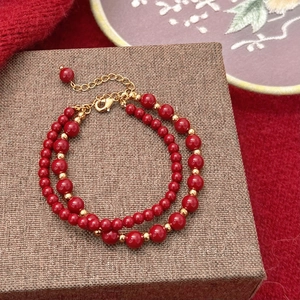 Bracelet élégant en perles rouges et dorées avec chaîne réglable sur boîte cadeau