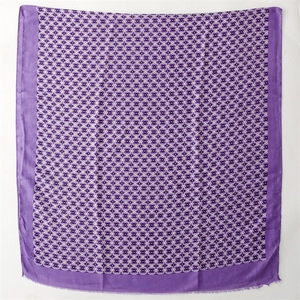 Detailed close-up of geometric pattern and frayed edge on purple cotton scarf