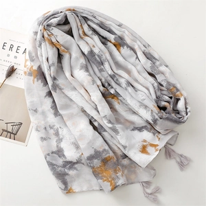 Detail of grey ink wash print scarf with soft tassels and minimalist artistic pattern