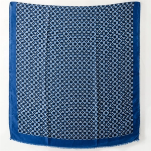 Detailed view of the dark blue geometric floral pattern scarf with soft fringe edges