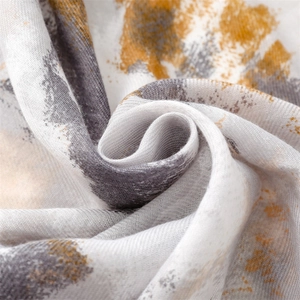 Macro detail of soft cotton scarf featuring abstract grey and yellow ink painting texture