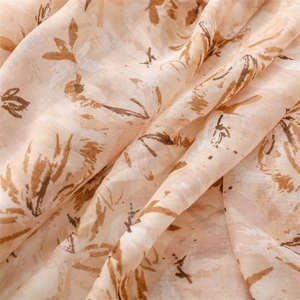 Detailed macro view of soft linen-feel scarf fabric with floral abstract patterns