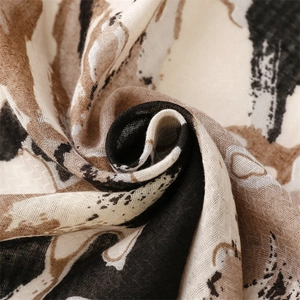 Detailed macro view of soft cotton-linen texture scarf with abstract ink heart pattern