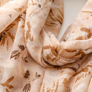 Close-up of lightweight cotton linen scarf with ink floral prints and soft texture