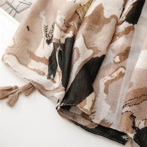 Close-up of cotton linen scarf featuring earthy abstract patterns and fringe details