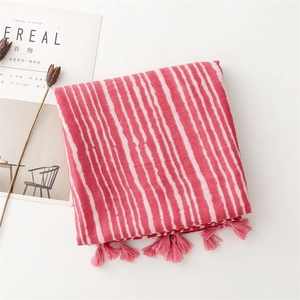 Detail shot of pink and white striped cotton-linen scarf with elegant fringed tassels