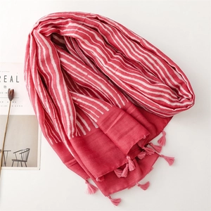 Detailed view of red and white striped cotton-linen scarf with soft pink fringe tassels