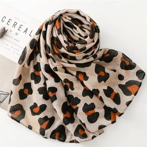 Detail of leopard print scarf with orange and black accents on a Cereal magazine background