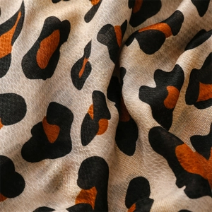 Close-up of leopard print scarf showing detailed soft cotton-linen texture and patterns