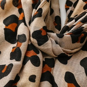 Detail of leopard print scarf showing soft texture and premium stitched rolled edges
