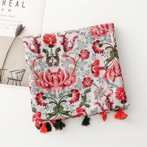 Detail of floral print cotton linen scarf with elegant tassels and vintage patterns