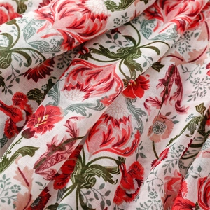 Close-up of red floral print on breathable cotton linen scarf with soft texture