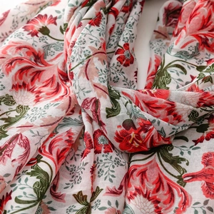 Close-up of floral print cotton-linen scarf with red blossoms and green leaves detail