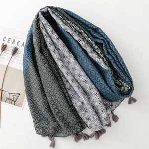 Geometric print scarf with tassels in retro color blocking on minimalist background