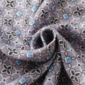 Detailed view of purple geometric pattern scarf fabric with soft woven texture