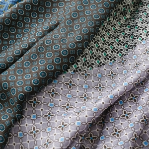 Detailed macro view of various retro geometric and floral prints on thick winter scarves