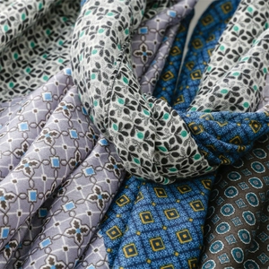 Close-up of thick winter scarves showing geometric patterns and fine woven texture details