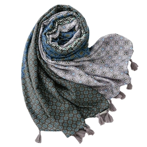 Thick geometric print scarf with bohemian patterns and grey tassel edges in blue tones